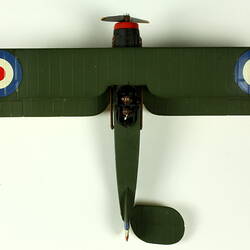 Dark green aeroplane model with red, white, blue circle on each wing. View from above.