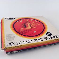 Half front view of electric blanket box with photo of woman.