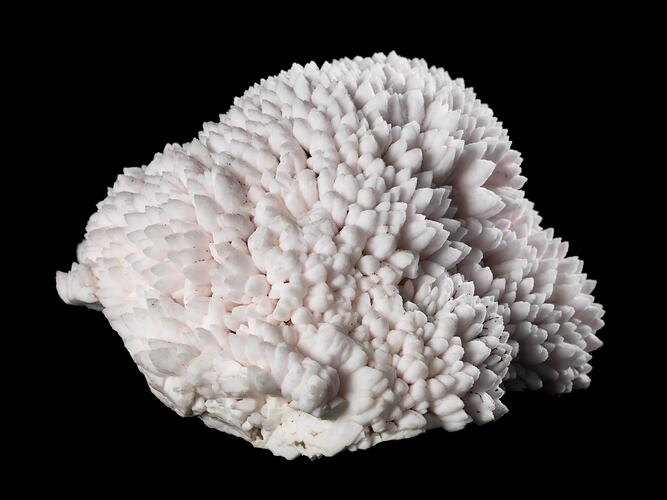 Pale pink mineral specimen.