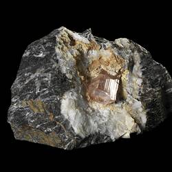 Punk column-like crystal on grey and white rock.