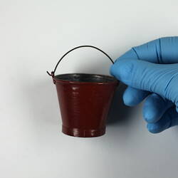 Red toy bucket.