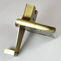 Brass metal support with securing screws.