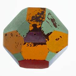 Wooden crystal model painted red, blue, green and orange.