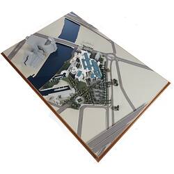 Cardboard model of building with two silver domes. Beside it is a river with a bridge.