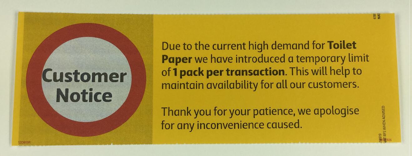 Red and yellow supermarket customer notice for toilet paper limit.