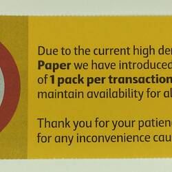Red and yellow supermarket customer notice for toilet paper limit.