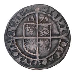 Round silver coin divided into quarters with central shield, '1575' above and text around edge.