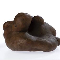 Irregularly shaped brown model of a potato.