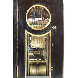 Side view of a clock in a balck and gold case.
