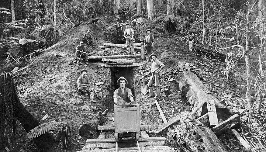 [A miner pushing a rail trolley out of a mine shaft, Gippsland, about 1895.]