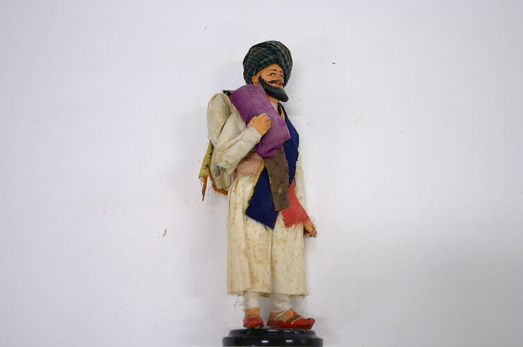 Indian Figure - Man Holding Purple Bundle, Clay, circa 1866