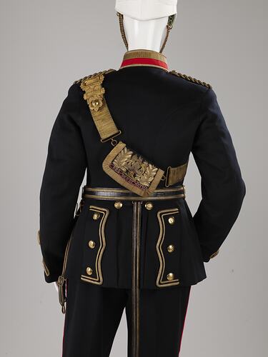 Back of navy officer's uniform with gold detail sash, jacket base, belt. Red and gold collar.