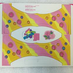 Paper with pop out pink and yellow decoration for a Barbie doll.