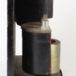 Sectioned Smith's carburettor on black stand. Right profile.