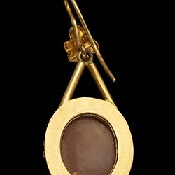 Back of gold mounted cameo earrings with brown centre, gold border.