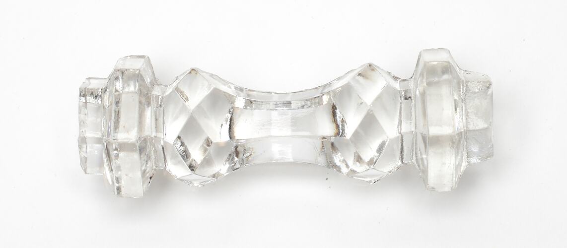 Ornately cut clear glass knife rest.