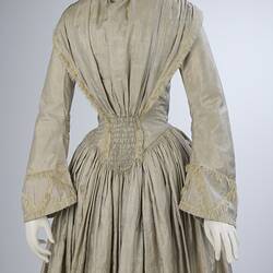 Pale grey striped silk dress with long sleeves and long skirt. Detail of top and mid section.