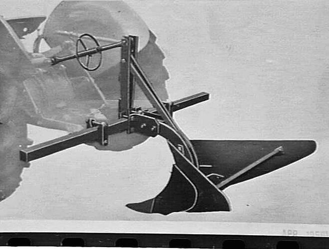 Tractor with plough.