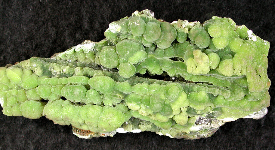 Green mineral with mutliple rounded sections.