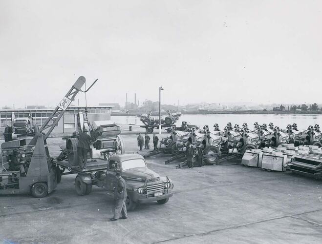Men at Port Melbourne wharf unloading No.6 Header Harvesters.