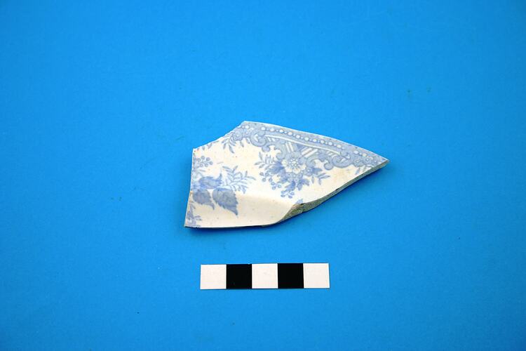 White and blue ceramic fragment.