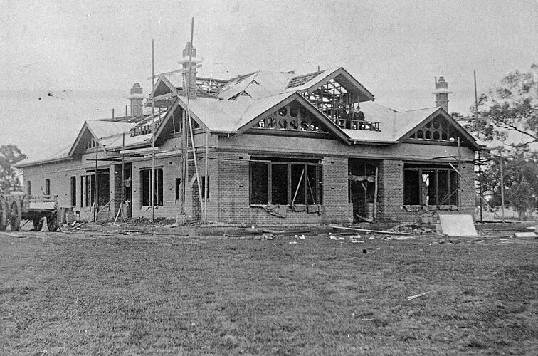 Black and white photograph of a building under construction.