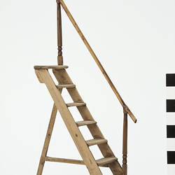 Fixed step ladder with hand rail.