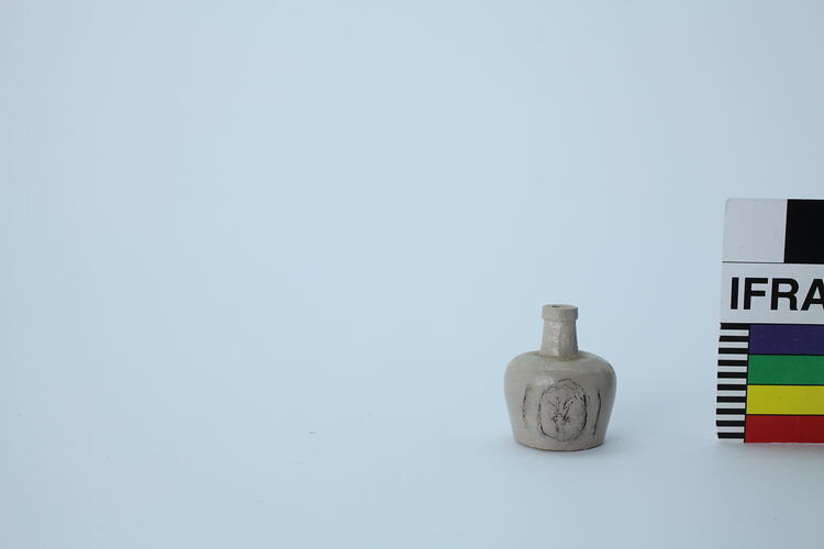Miniature beige jug with black motif