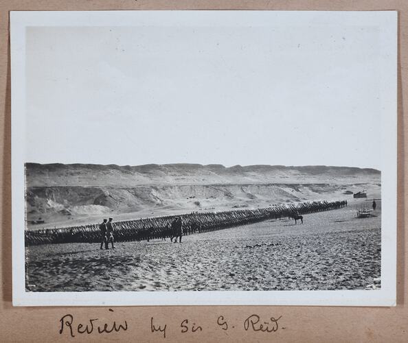 Large group of soldiers standing in formation, handwritten text below.