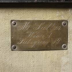 Address plate riveted to canvas lined wooden trunk