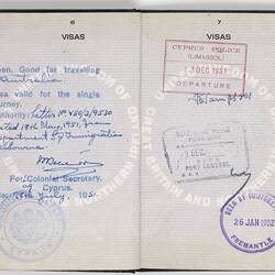 Open passport with white pages, black printing and blue handwriting. Stamped.