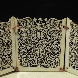 Detail of the intricately carved sides of an ivory basket.