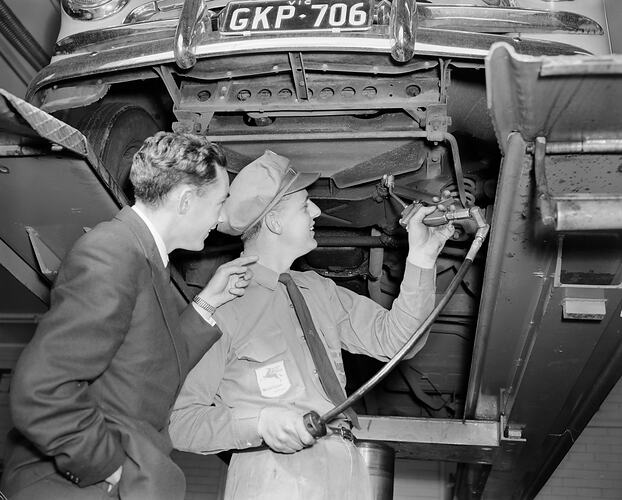 Two Men with Car on Hoist, Melbourne, Victoria, 1958