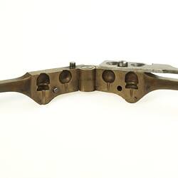 Open hand-held brass bullet mould. Detail of moulding shapes.