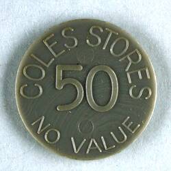 Grey plastic circular disc, printed on each side; 'COLES STORES 50 NO VALUE'.