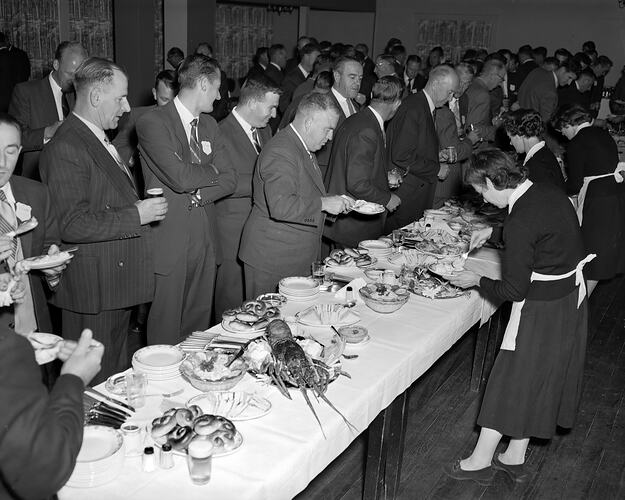 Men Standing at a Food Buffet, Victoria, 07 Apr 1959