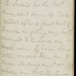 Open diary with handwritten text on discoloured worn page.