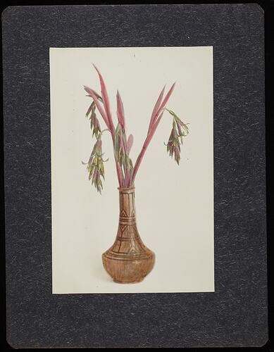 Still life of red and green flowers in a brown vase.