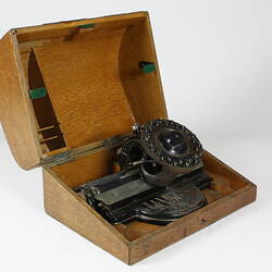 Open box containing a typewriter.