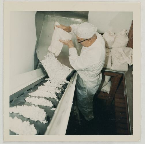 Man Loading Granulated Silver Onto Conveyor Belt, Kodak Factory, Coburg, circa 1960s