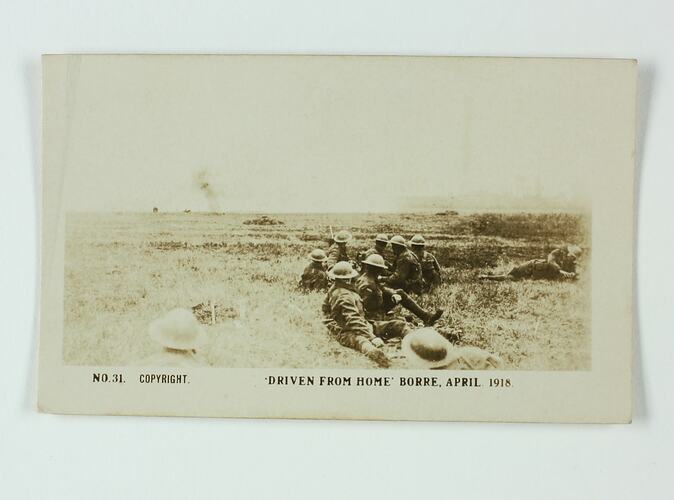 Soldiers sitting in a field.