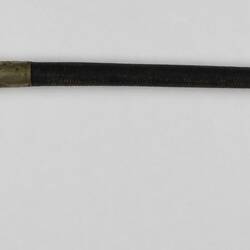 Riding crop with leather covered handle and silver detail.