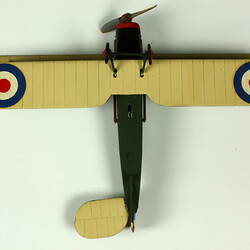 Dark green aeroplane model viewed from underside with red, white, blue circle on each white wing.