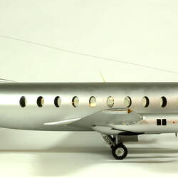 Silver model aeroplane with two propellers on each wing. Profile.