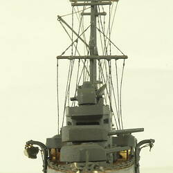 Naval ship with two masts, front view.