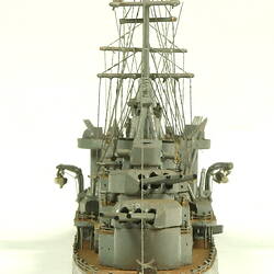 Naval ship with two masts, rear view.