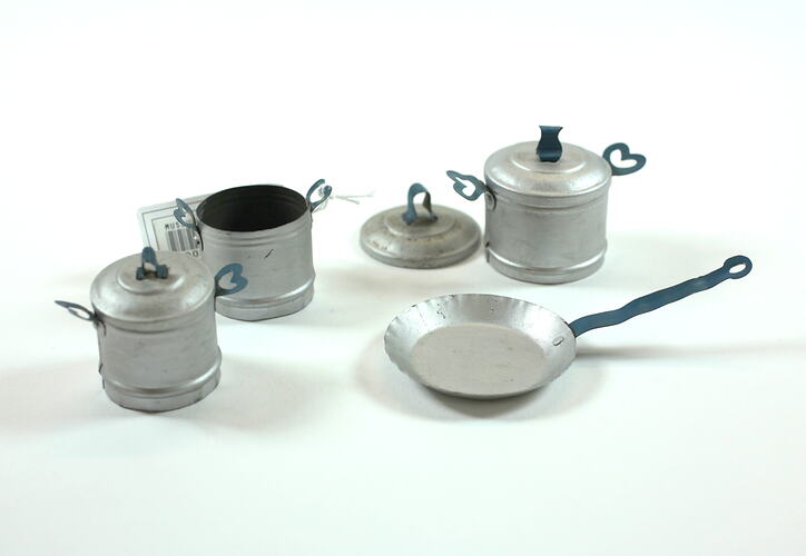 Toy silver pots and a frying pan.
