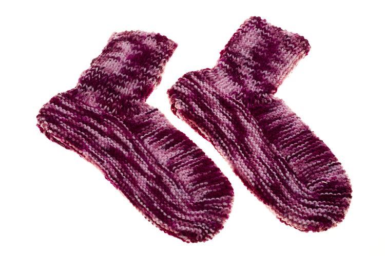 Purple mottled handknitted socks.