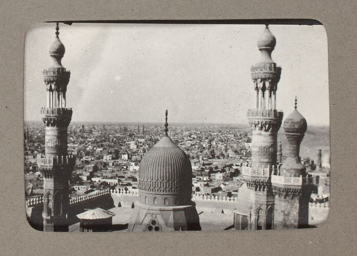 Minarets against low-rise city skyline.