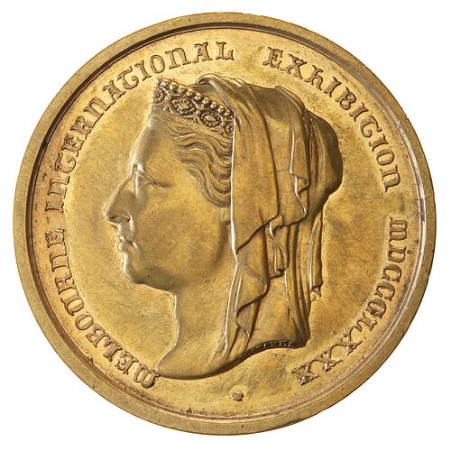 Round medal with portrait of woman.